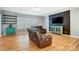 Modern living room with hardwood floors, an accent wall, and comfortable seating, perfect for relaxation at 2222 Bluebell Way, Fort Mill, SC 29708