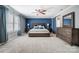 This primary bedroom features a ceiling fan, a blue accent wall, and an ensuite at 2222 Bluebell Way, Fort Mill, SC 29708