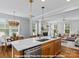 Kitchen with white marble island and stainless steel appliances adjacent to living and dining areas at 272 Gilead Rd, Huntersville, NC 28078