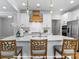 Kitchen island with white quartz countertop and wooden stools at 272 Gilead Rd, Huntersville, NC 28078