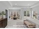 Bright main bedroom featuring a sitting area with large windows and an elegant tray ceiling at 272 Gilead Rd, Huntersville, NC 28078