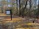 Wooded lot for sale, featuring a For Sale sign at 295 Tradition Dr, Mount Gilead, NC 27306