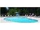 Inviting kidney-shaped pool with surrounding lounge chairs at 295 Tradition Dr, Mount Gilead, NC 27306