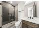 Elegant bathroom featuring a glass shower, gray tile, and modern fixtures at 3132 Carol Ave, Charlotte, NC 28208
