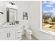 Clean, modern bathroom featuring single sink vanity and large window at 3132 Carol Ave, Charlotte, NC 28208