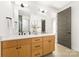 Bright bathroom featuring a double vanity with modern fixtures and neutral finishes at 3132 Carol Ave, Charlotte, NC 28208