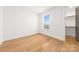 Simple bedroom featuring hardwood floors, a closet, and a window at 3132 Carol Ave, Charlotte, NC 28208