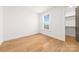 Clean bedroom with hardwood floors, large window and walk-in closet at 3132 Carol Ave, Charlotte, NC 28208