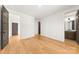 Spacious bedroom with hardwood floors and neutral paint, with attached bath access at 3132 Carol Ave, Charlotte, NC 28208