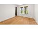 Sun-filled bedroom features wood floors, white walls and trim, and a double window at 3132 Carol Ave, Charlotte, NC 28208