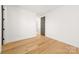 Clean, minimal bedroom with hardwood floors and lots of light at 3132 Carol Ave, Charlotte, NC 28208