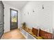 Cozy entryway with a decorative bench, hooks, and hardwood floors at 3132 Carol Ave, Charlotte, NC 28208