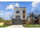 Modern home with gray garage, white siding, wooden facade, and black trim windows at 3132 Carol Ave, Charlotte, NC 28208