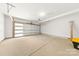 Clean, well-lit garage with an automatic door and concrete flooring at 3132 Carol Ave, Charlotte, NC 28208