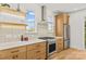 Well-lit kitchen with stainless steel appliances, wooden cabinets, and white countertops at 3132 Carol Ave, Charlotte, NC 28208