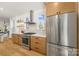 Beautiful kitchen with stainless steel appliances, white countertops, and light wood cabinets at 3132 Carol Ave, Charlotte, NC 28208