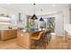 Kitchen island with modern light fixtures, stainless steel appliances, and barstool seating at 3132 Carol Ave, Charlotte, NC 28208