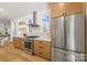 Modern kitchen featuring stainless steel appliances, bright white counters, and a window view at 3132 Carol Ave, Charlotte, NC 28208