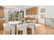 Bright kitchen featuring a glass dining table, an island, modern lighting, and an outdoor view at 3132 Carol Ave, Charlotte, NC 28208