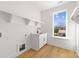 Well lit laundry room with a window view and wooden floors at 3132 Carol Ave, Charlotte, NC 28208