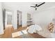 Bright main bedroom featuring hardwood floors, a ceiling fan, and closet access at 3132 Carol Ave, Charlotte, NC 28208