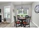 Bright dining area with large windows, pendant lighting, and a view of the backyard at 3134 Sterling Ct, Fort Mill, SC 29707