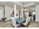 Open-concept dining area adjacent to living space with elegant lighting and modern furniture at 3134 Sterling Ct, Fort Mill, SC 29707