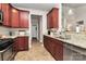 Kitchen with stainless steel appliances, granite countertops, and cherry wood cabinets at 3134 Sterling Ct, Fort Mill, SC 29707