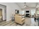 Cozy living room with a fireplace, neutral walls, ceiling fan, and modern decor at 3134 Sterling Ct, Fort Mill, SC 29707