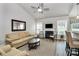 Spacious living room with fireplace, ceiling fan, bar seating, and lots of natural light at 3134 Sterling Ct, Fort Mill, SC 29707