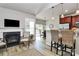 Open living space with a fireplace, bar seating, and kitchen in the background at 3134 Sterling Ct, Fort Mill, SC 29707