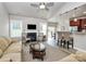 Living room featuring a fireplace, vaulted ceilings, wood floor, and breakfast bar at 3134 Sterling Ct, Fort Mill, SC 29707