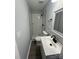 Clean bathroom with white vanity, tiled shower, and dark gray flooring at 317 Echodale Dr, Charlotte, NC 28217