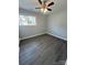 Spacious bedroom with gray walls, wood-look floors, and a ceiling fan at 317 Echodale Dr, Charlotte, NC 28217