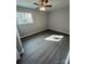 Well-lit bedroom with gray walls, wood-look floors, and a window at 317 Echodale Dr, Charlotte, NC 28217