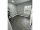 Functional laundry room with gray walls, wood-look floors, and a water heater at 317 Echodale Dr, Charlotte, NC 28217