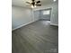 Spacious living room featuring gray walls, wood-look floors, and a ceiling fan at 317 Echodale Dr, Charlotte, NC 28217