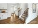 Inviting entryway with luxury vinyl plank flooring, adjacent to a carpeted staircase with wooden handrail at 4626 Harris Elliot Rd, Lincolnton, NC 28092