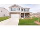 Two-story house with stone accents, a white garage door, and a neatly landscaped lawn at 4626 Harris Elliot Rd, Lincolnton, NC 28092