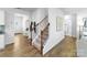 Modern staircase with dark wood railing and carpeted steps, leading to the upper floor at 4626 Harris Elliot Rd, Lincolnton, NC 28092