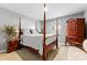 Bedroom featuring four poster bed, hardwood floors, and classic furnishings at 5025 Macvittie Ln, Charlotte, NC 28214