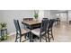 Dining area with modern wood table and chairs, plants, and light flooring at 5025 Macvittie Ln, Charlotte, NC 28214