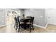 A dining room featuring a dining table and chairs with natural light through a large window at 5025 Macvittie Ln, Charlotte, NC 28214