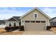 A well-maintained home features a beige two-car garage with a classic design at 5025 Macvittie Ln, Charlotte, NC 28214