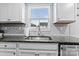 Bright kitchen sink with granite countertops, gray tile backsplash, and stainless steel appliances at 5025 Macvittie Ln, Charlotte, NC 28214