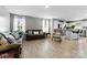 Bright living room with hardwood floors and neutral decor connecting to the kitchen area at 5025 Macvittie Ln, Charlotte, NC 28214