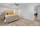 Cozy bedroom with a wooden bed frame, neutral bedding, and a patterned rug at 503 Brookfield Cir # 1, Salisbury, NC 28146