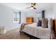 Bright bedroom with large windows, ceiling fan, and hardwood dresser at 503 Brookfield Cir # 1, Salisbury, NC 28146