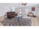 Bright living room with wood floors, leather sofa, and a large area rug at 503 Brookfield Cir # 1, Salisbury, NC 28146