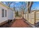 View of the side of a home showcasing its gravel path and fenced yard at 506 S Church St, Salisbury, NC 28144